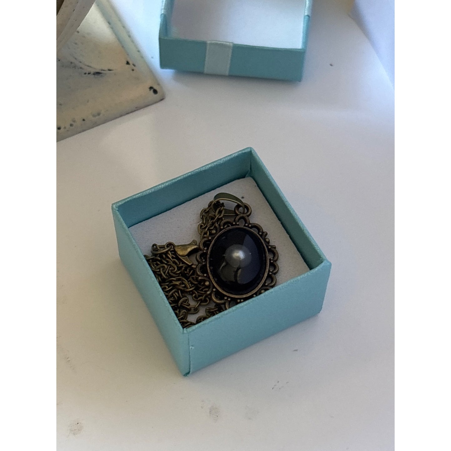 Floating Pearl Pendant Oval Black Background: Handmade in San Diego