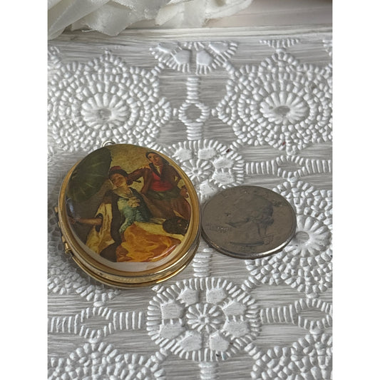 Vintage Gold Tone Oval Locket With Painted Scene Of Couple & Umbrella Hinged Design Holds Two Photos